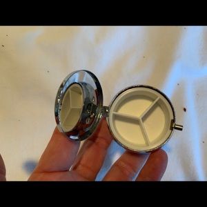 Small round travel pillbox from Hallmark. Has 3 compartments.
